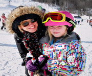 Mom and daughter skiing
