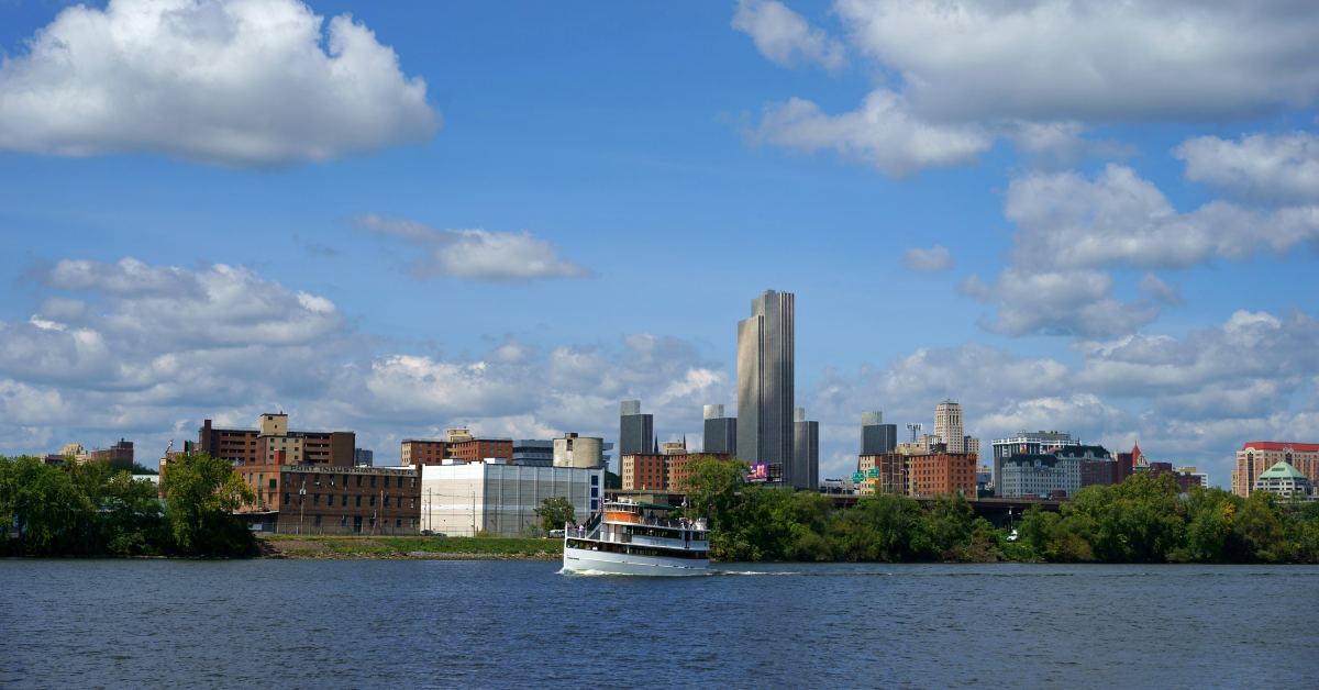 boat floating along the hudson river with the albany skyline in the background