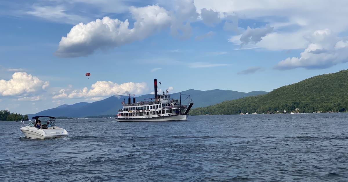 boat and steamboat on lake george in summer