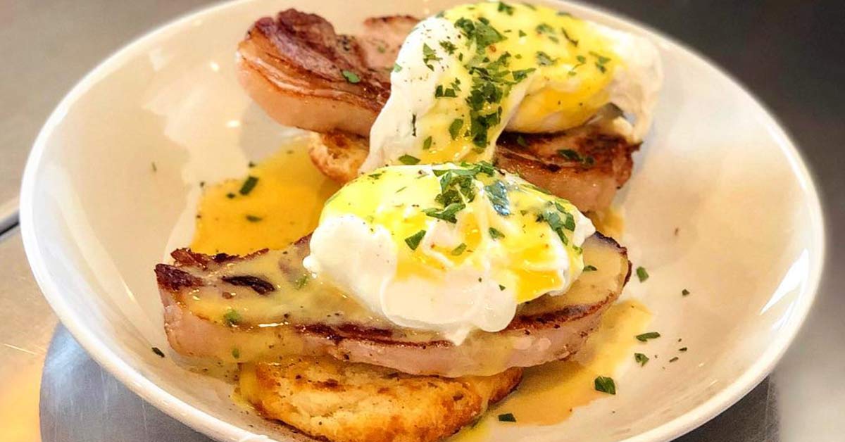eggs benedict on a white plate