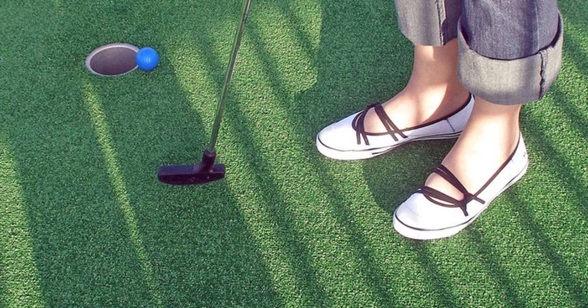 close up of a woman's shoes as she mini golfs
