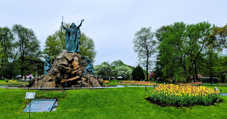 a statue near tulips in Washington Park