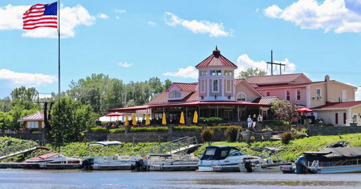 restaurant on the waterfront with boats on the shoreline